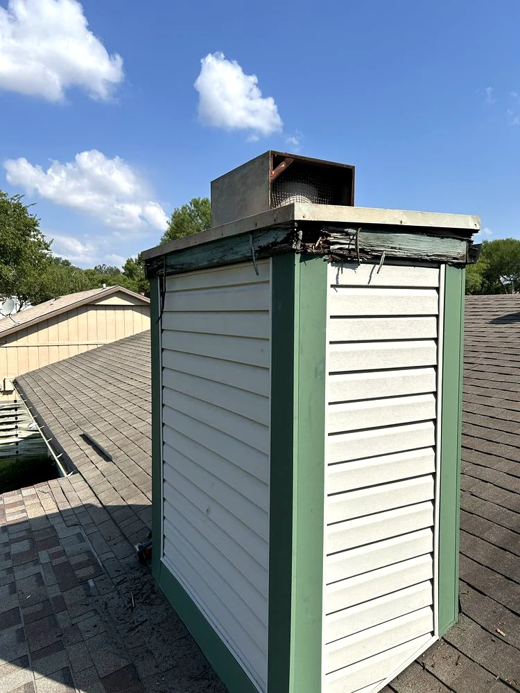 Before: damaged wood trim along the top of the chimney enclosure.