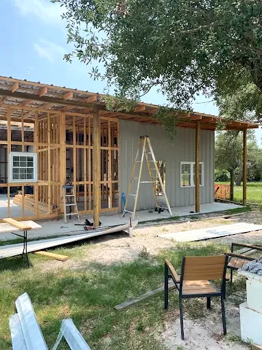 A home exterior during a framing and finish project, with work still underway.